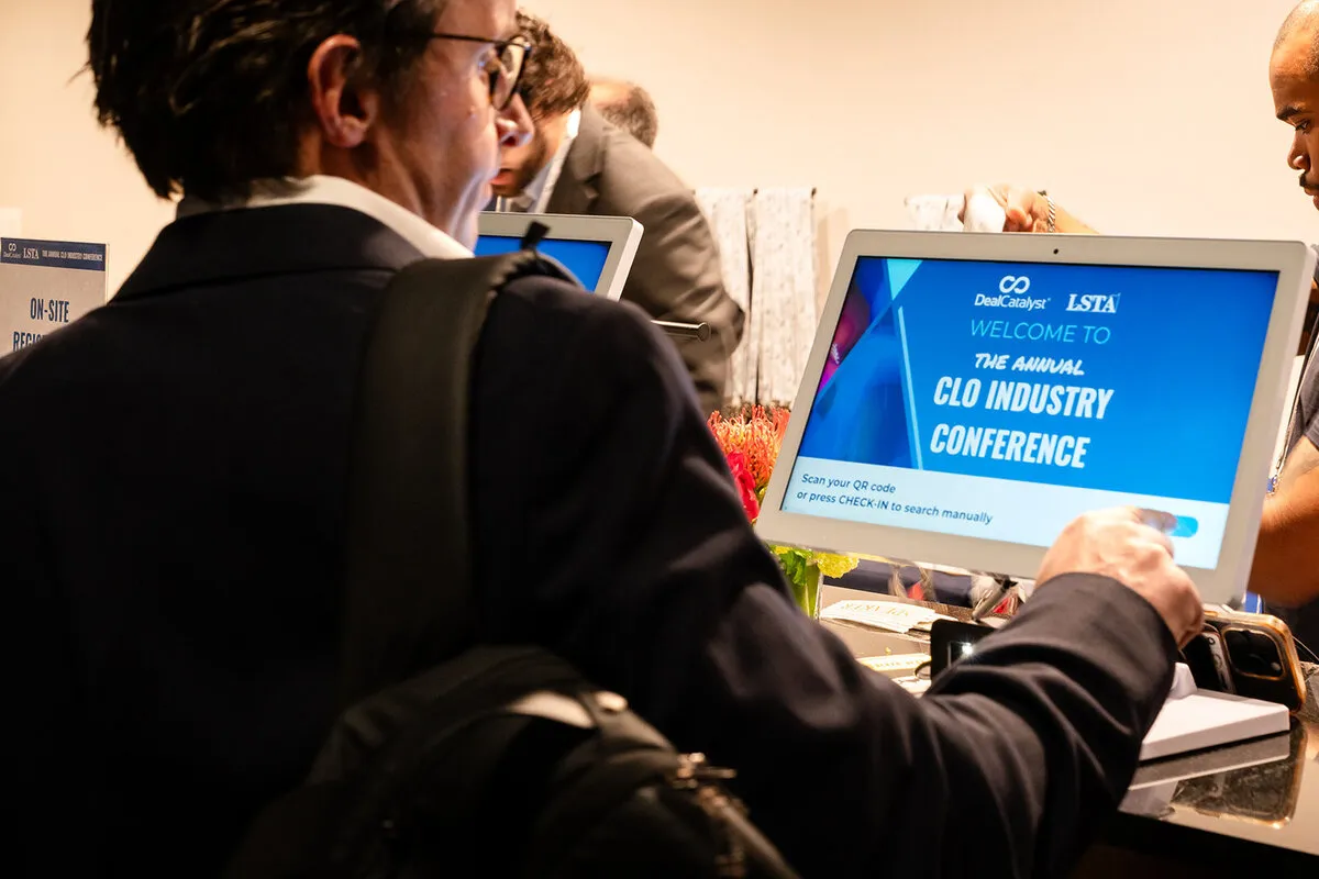 Delegate checking in at an on-site conference registration terminal