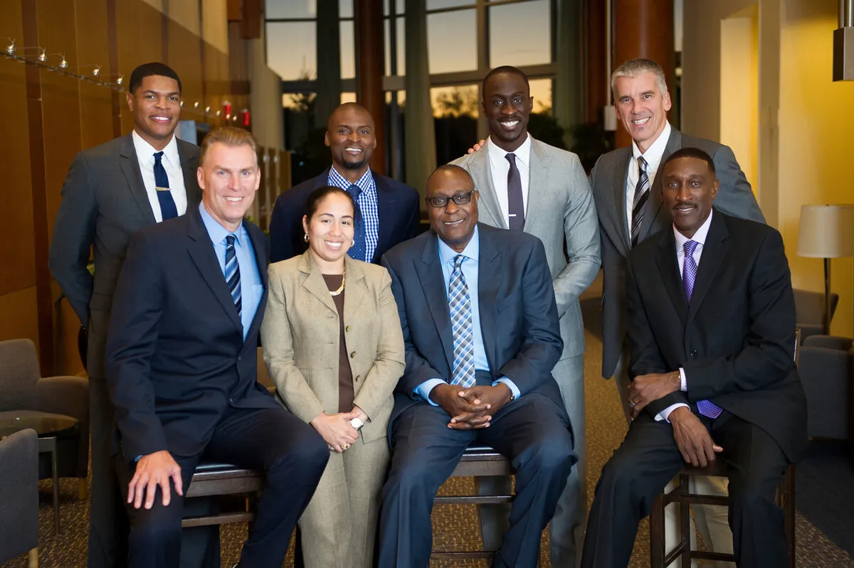 Group portrait of nine executives photographed on location in an office lobby